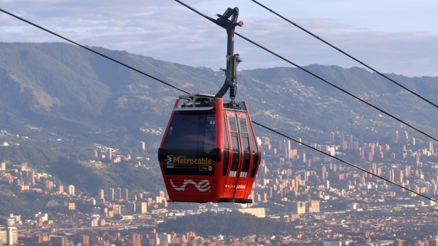 © UNE sponsored cablecars rise above the City of Medellin