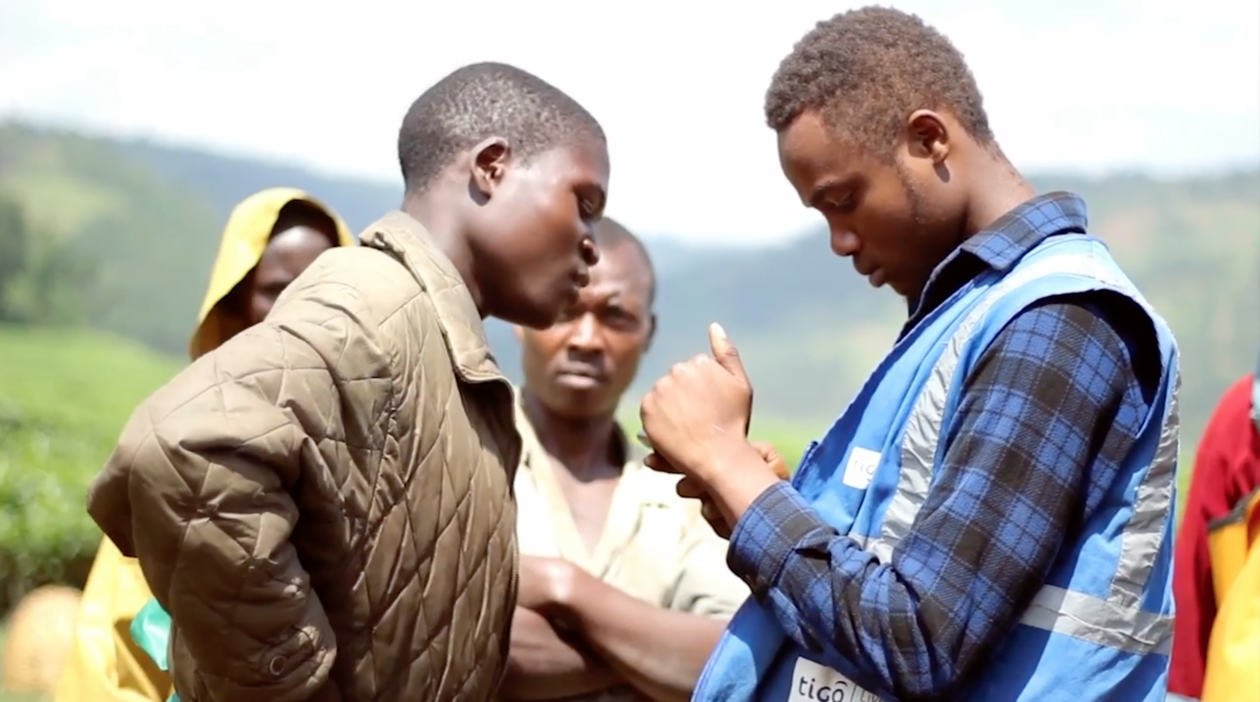 ©Tigo Cash agent introduces one of Rwanda's 10,000 tea farmers to mobile banking - July 2016.